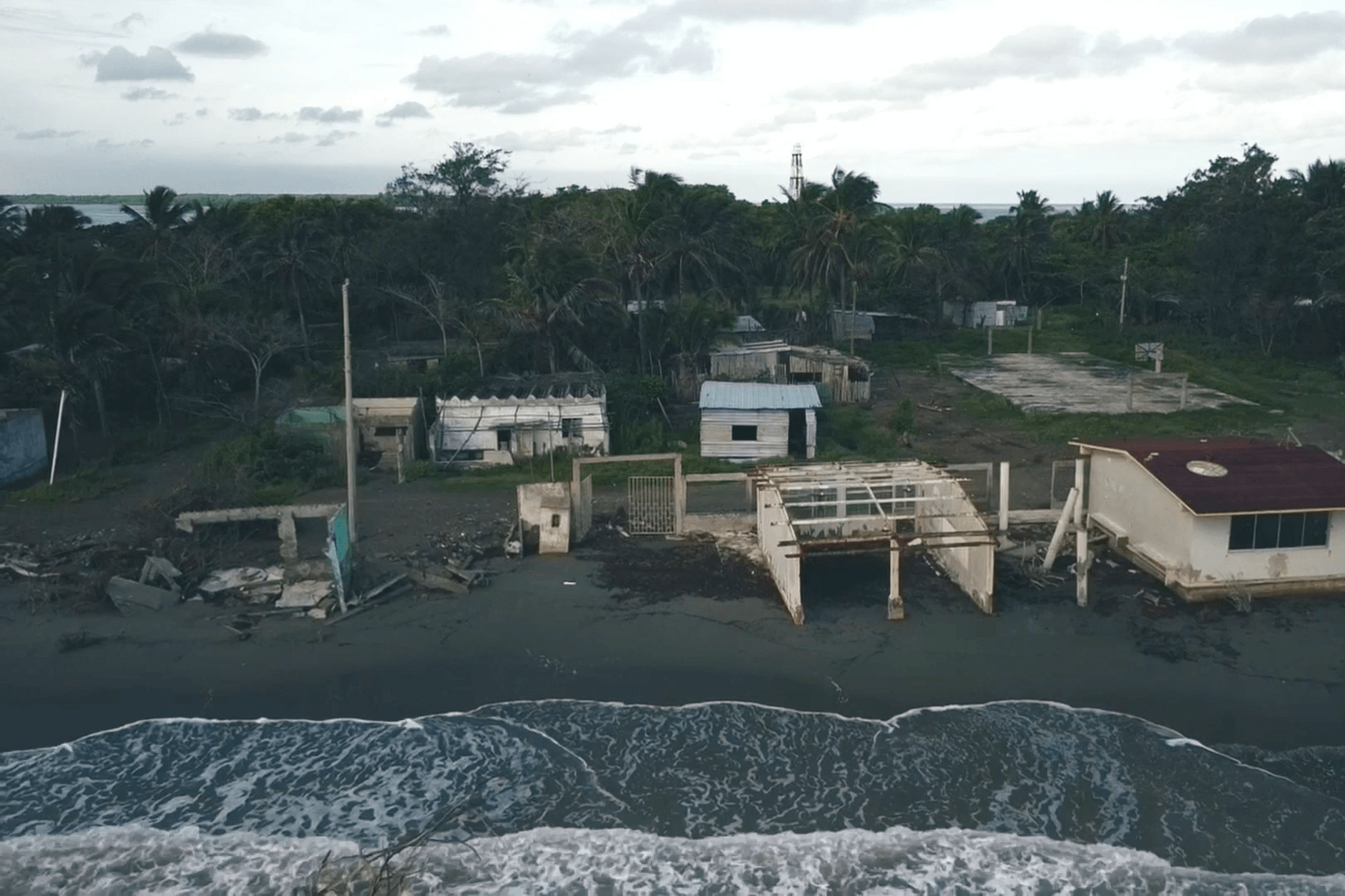 A shoreline with flood damaged houses