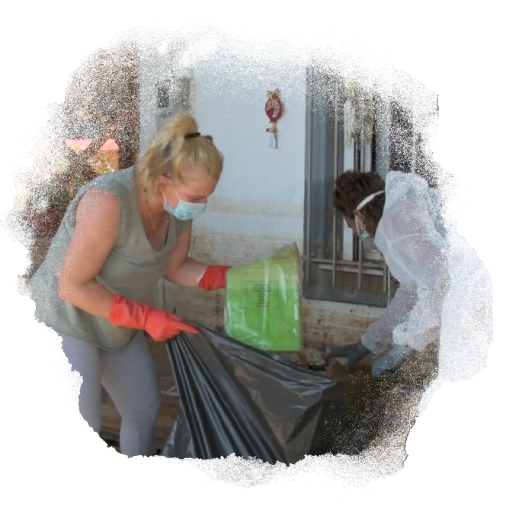 A photo of Vasiliki clearing up flood damaged objects