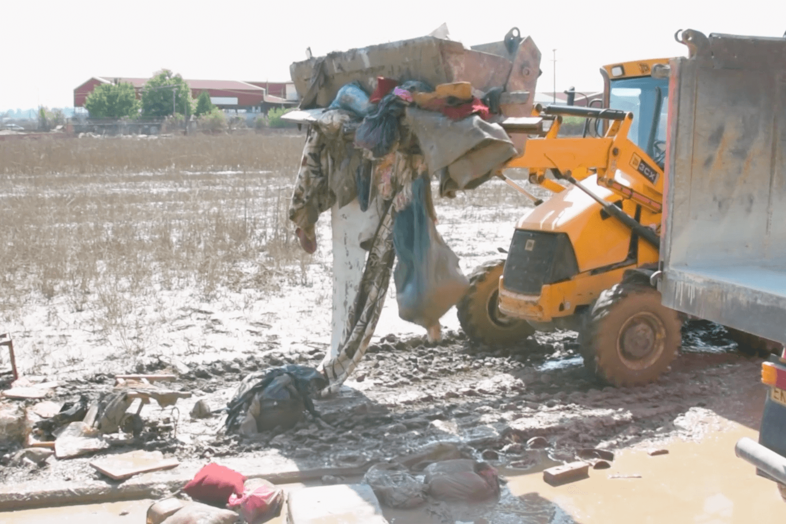 A photo of an excavator removing debris 