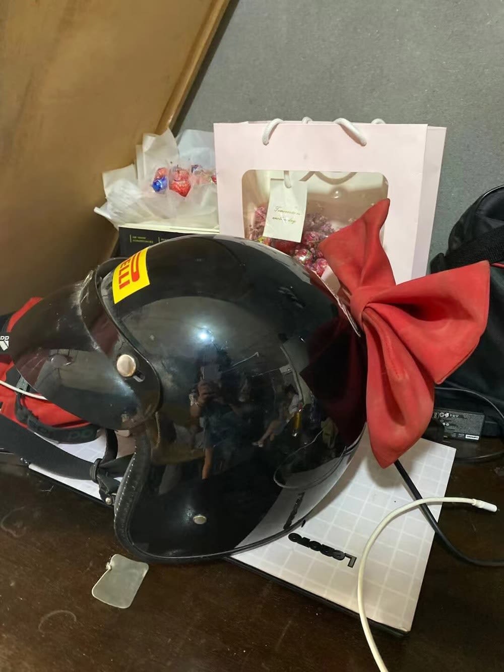 A photo of Wu Puhui's object of memory: a bike helmet with a red ribbon