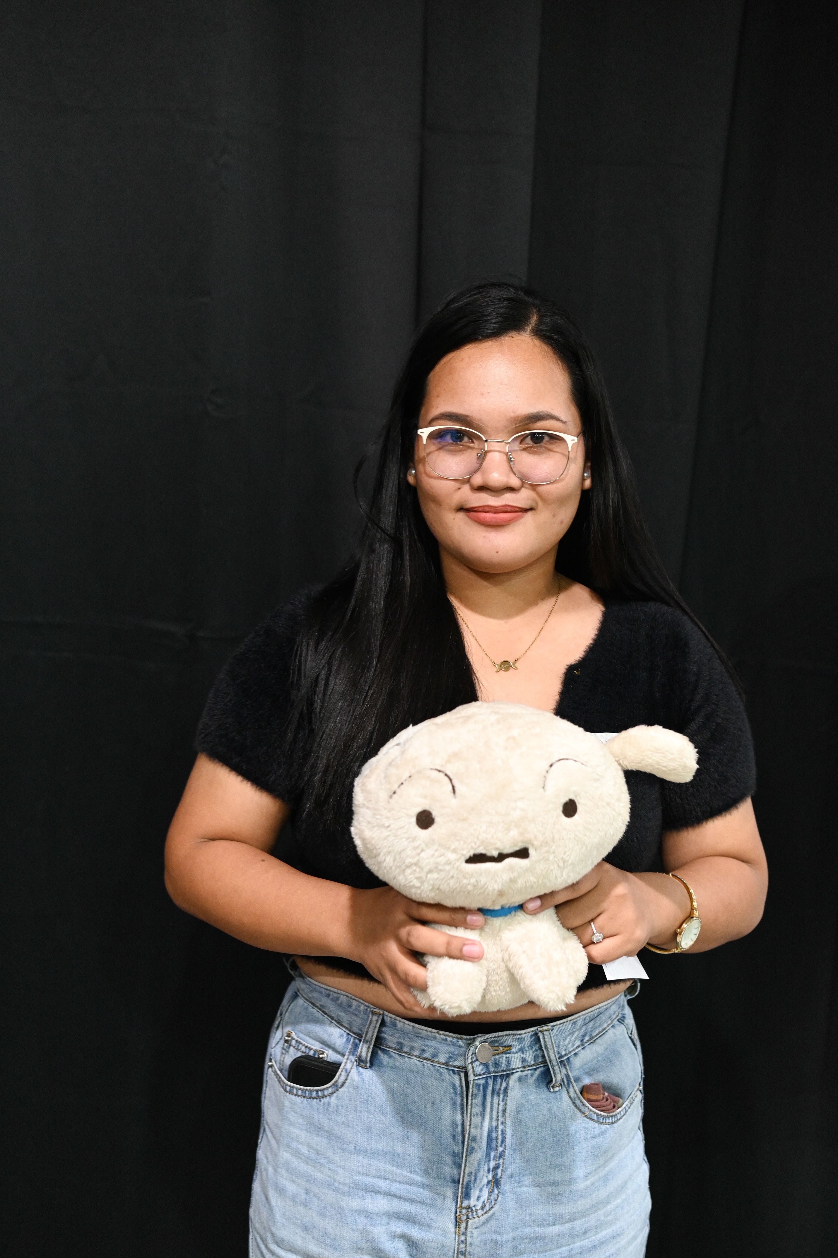 A photo of Shane Carmacete holding her object of memory: a stuffed toy